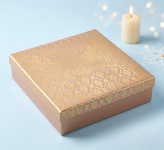 Rose gold box on a pale blue backdrop