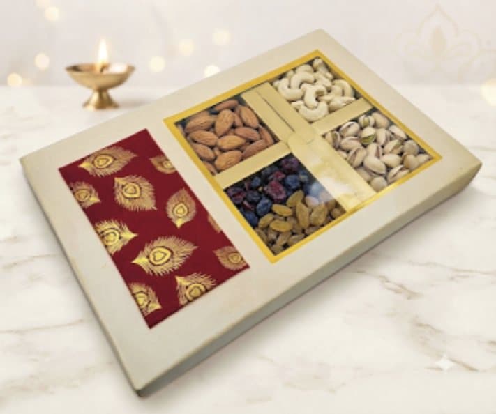 Open gift box of almonds, cashews, pistachios and raisins
